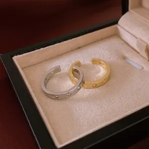 Minimalist zircon star open ring set in gold and silver finish on velvet display