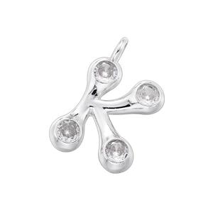 Macro detail of silver bamboo style letter K pendant with four clear gemstones