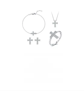 Macro shot of 925 silver jewelry set with moissanite cross pendant and ring engraving
