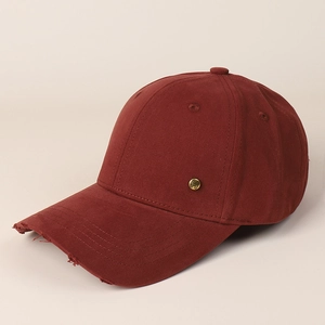 Close-up of distressed brim on dark red baseball cap with a gold H metal buckle