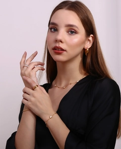 Detailed close-up of 18K gold plated heart necklace, bracelet, and ring jewelry set