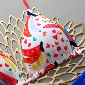 Detail of white bikini top with banana heart print and adjustable drawstring triangle cups