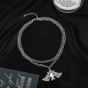 Close-up of a silver double layer punk necklace with a detailed spider pendant on black velvet