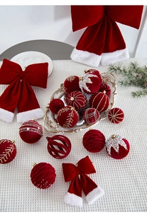 Detail of red velvet Christmas ornaments with gold embroidery and festive bows