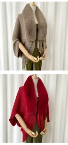 Detail of elegant knit shawl featuring a plush faux fur collar and long fringe trim accents