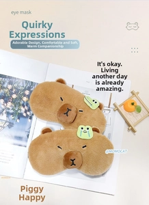 Close-up of plush Capybara eye masks featuring cartoon crocodile and crying frog details