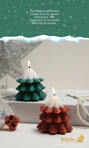 Macro detail of red and green Christmas tree scented candles with snow texture and pine needles