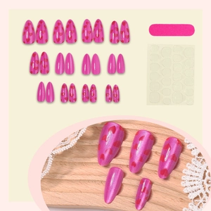 Pink cat-eye press-on nails set with red hearts and professional application tools