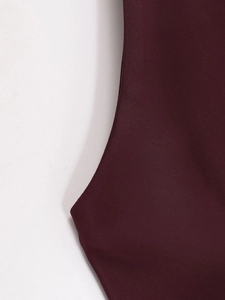Detail view of wine red satin fabric with high-quality stitching and smooth texture