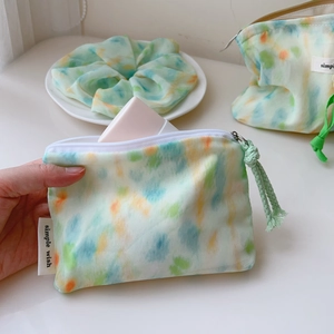 Detail of mint green watercolor cotton pouch and matching hair scrunchie set