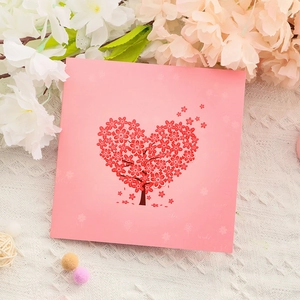 Pink Mother's Day popup card with heart-shaped cherry blossom tree on white knit background