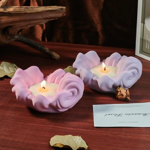 Set of two flower petal candles in pink and purple shades for romantic home decoration