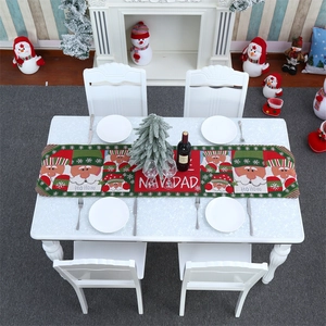 Detail of knitted Christmas table runner with Santa Claus pattern and NAVIDAD lettering