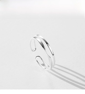 Macro view of polished S925 sterling silver double-layered open ring with shadows