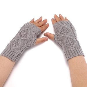 Close-up of grey knitted jacquard fingerless gloves shown on a model's hands