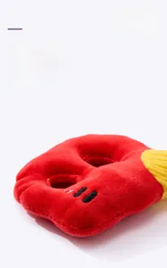 Close-up of seamless stitching on a red plush squeaky dog toy with durable texture