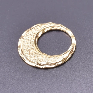 Detail of 18k gold plated stainless steel C-shape pendant with hammered texture finish