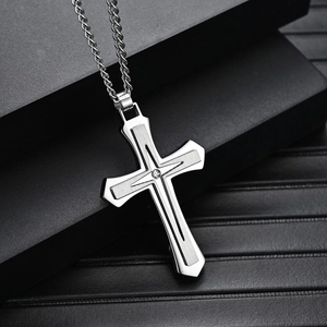 Men's 316L stainless steel two-tone cross necklace with central stone on black pedestal
