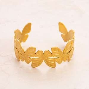 Detailed close-up of 18k gold plated stainless steel cuff bracelet with butterfly motif
