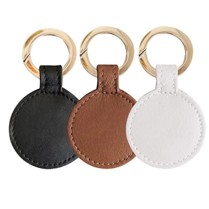 Leather magnetic hat clips in black, brown, and white with metal rings on white background