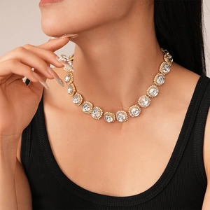 Close-up of luxury gold tennis necklace with sparkling cubic zirconia on model neck