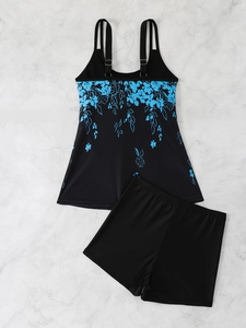 Detail view of two-piece tankini set featuring floral print top and black swim shorts