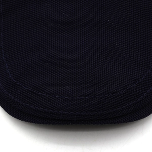 Macro detail of navy mesh cap brim featuring reinforced stitching and breathable fabric