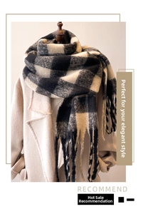 Detailed view of black and white plaid scarf with tassels on a beige wool coat