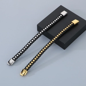 Macro detail of braided leather bracelets with silver and gold magnetic metal clasps
