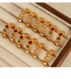 Detailed close-up of 18K gold plated steel earrings with zircon and natural stones