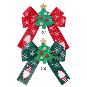 Detail of Christmas ribbon hair clips with snowflake patterns and festive Santa gnome designs