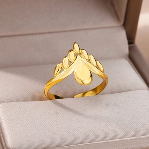 Detail of 18k gold-plated crown ring with teardrop center in a beige jewelry box