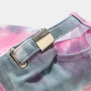 Detail of adjustable metal buckle on colorful tie-dye cotton baseball cap