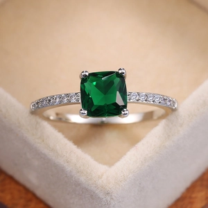 Elegant silver ring with a square emerald-cut blue stone and zircon side accents
