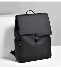 Modern black waterproof business backpack with tactical buckle on a geometric stand