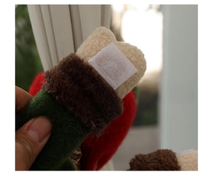 Christmas plush decoration detail showing hook and loop closure for easy attachment