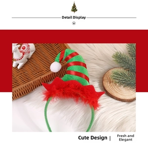 Detail of red and green elf hat headband with feathers and pom-poms for Christmas