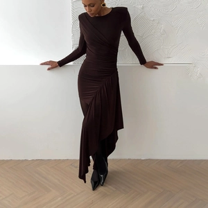 Detail of dark brown bodycon dress featuring elegant diagonal ruching and asymmetric hem