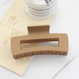 Detail of matte caramel square hair claw clip with large rectangular hollow design