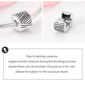 Detailed macro view of S925 sterling silver clip charm with striped pattern and S925 stamp