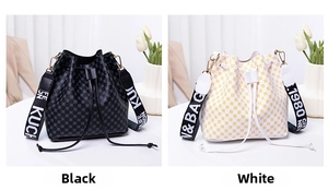 Close-up of drawstring bucket bags in black and white with wide graphic straps