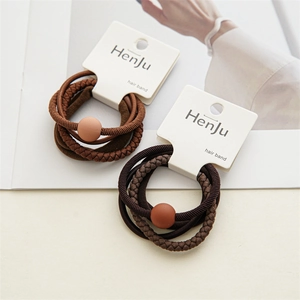 Close-up of a 3-piece hair band set in brown and dark coffee tones on a fashion magazine