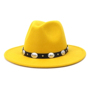 Close-up of bright yellow wool fedora featuring black leather belt and silver metal studs