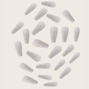 Sparkling silver glitter long ballerina press-on nails set on a beige background