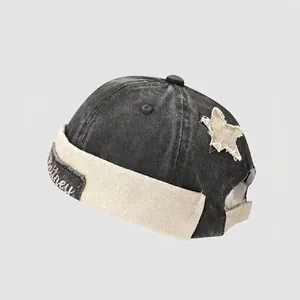 Detail of washed grey denim kids docker hat with star patch and Britney embroidery