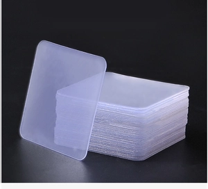 Stack of transparent square double-sided adhesive pads showing high clarity and thickness