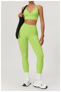Detail of high-waist fluorescent green yoga leggings with seamless moisture-wicking fabric