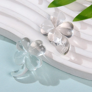 Close-up of transparent resin four-leaf clover charms for DIY jewelry and hair clips