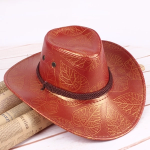 Close-up of red straw cowboy hat with gold leaf patterns and brown braided rope trim