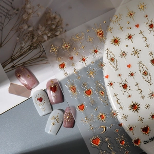 Luxury 5D gold celestial nail art stickers with moon, stars, and red heart relief details